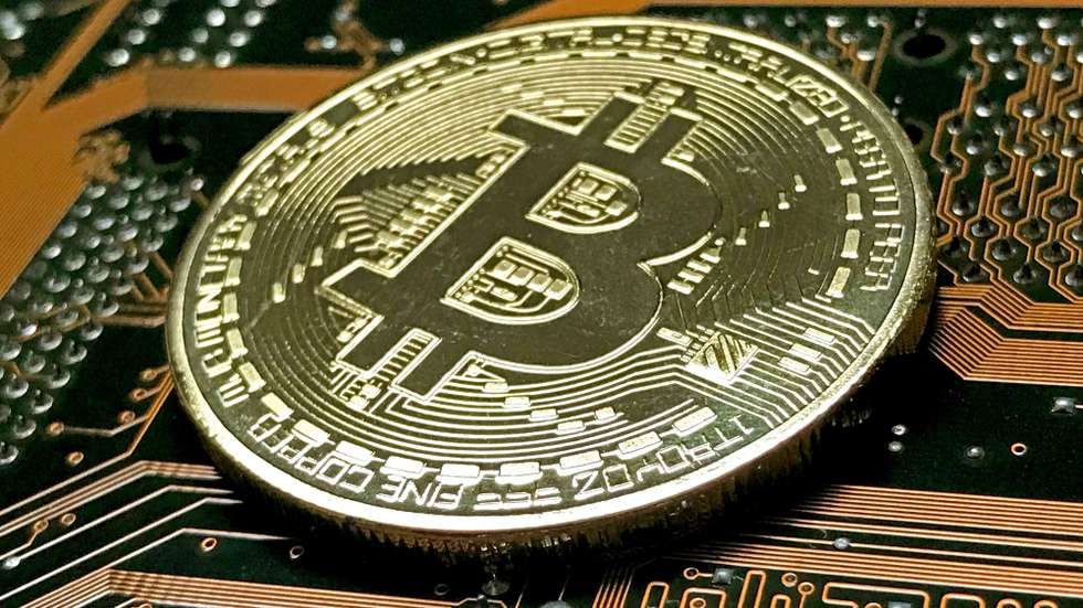 epa06403161 A golden symbolic Bitcoin is pictured in Duesseldorf, Germany, 22 December 2017. Bitcoin, the cryptocurrency that has soared in value this year, plunged below 11,000 Dollars on 22 December, sinking by nearly half from a record high it hit less than a week ago. The cryptocurrency, which allows anonymous transactions unrestricted by global borders, is popular with tech heads, people suspicious of government and those seeking to launder money.  EPA/SASCHA STEINBACH