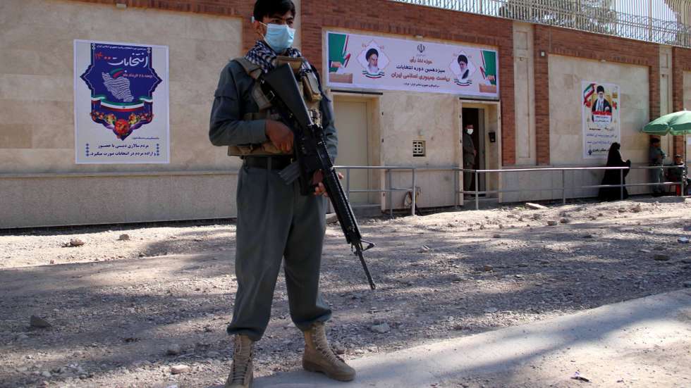 epa09281896 Afghan Police stand guard as Iranians living in Afghanistan (not pictured) cast their ballot in the Iranian presidential elections, at the Iranian consulate in Herat, Afghanistan, 18 June 2021. Iranians head to polls to elect a new president after eight years with Hassan Rouhani as head of state.  EPA/JALIL REZAYEE
