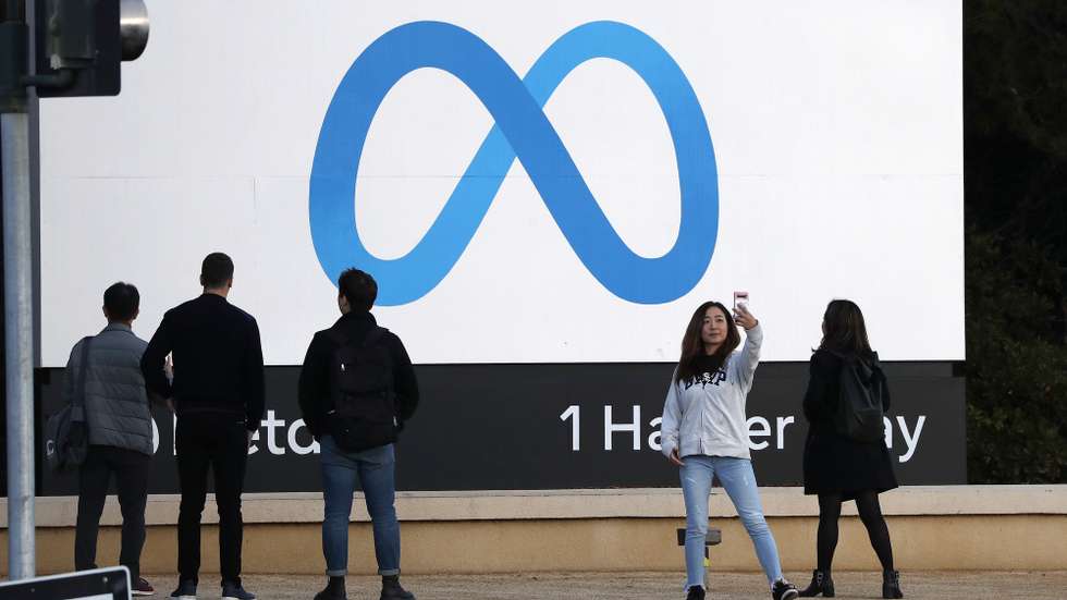 epa10296729 A person takes a selfie in front of the Meta billboard at the headquarters of Meta Platforms Inc., formerly named Facebook, Inc., in Menlo Park, California, USA, 09 November 2022. Chief Executive Mark Zuckerberg told company executives that Meta will begin laying off employees.  EPA/JOHN G. MABANGLO