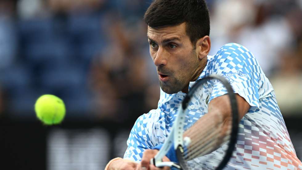 epa10419832 Novak Djokovic of Serbia in action against Grigor Dimitrov of Bulgaria during their third round match at the 2023 Australian Open tennis tournament in Melbourne, Australia, 21 January 2023.  EPA/LUKAS COCH  AUSTRALIA AND NEW ZEALAND OUT