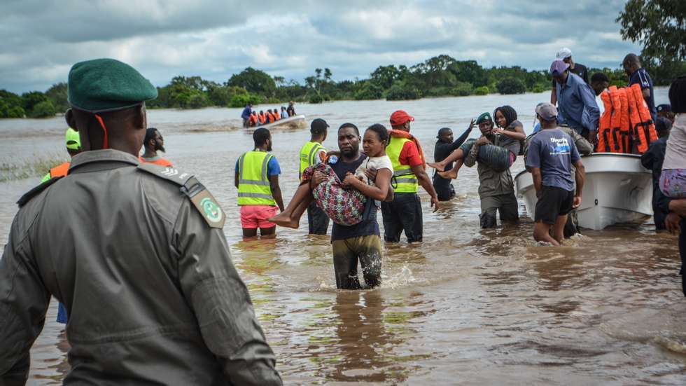 epa10461089 Locals are evacuated from flooded areas in Maputo, Mozambique, 11 February 2023. More than 300 people were rescued boats of the authorities, companies and individuals who have pulled them out of trees, roofs of houses or pieces of land that remained as islands. According to Mozambique&#039;s National Institute for Disaster Management (INGD) about 2,400 families have been affected with many of those in a critical situation.  EPA/LUIS FONSECA