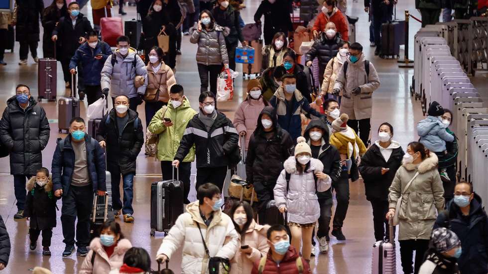 epa10416819 People walk along the Beijing West Railway Station in Beijing, China, 20 January 2023. China's health authorities reported that Covid-19 patients needing critical care have peaked as millions of people travel for Lunar New Year celebrations for the first time since the pandemic began.  EPA/MARK R. CRISTINO
