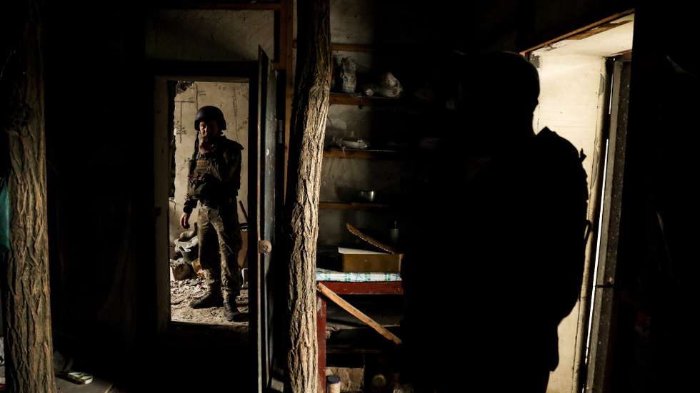 epa10650862 Ukrainian servicemen from the 24th Separate Mechanized Brigade 'King Danylo' stand inside a damaged building at a frontline position, at an undisclosed location in the Donetsk region, eastern Ukraine, 24 May 2023, amid the Russian invasion. Most of the town's some 10,000 inhabitants have deserted it because of the conflict. Some of the houses were destroyed while others are still standing. In its streets, pets, a few individuals can be seen while police and some communal services still continue to function. Russian troops entered Ukraine on 24 February 2022 starting a conflict that has provoked destruction and a humanitarian crisis.  EPA/OLEG PETRASYUK