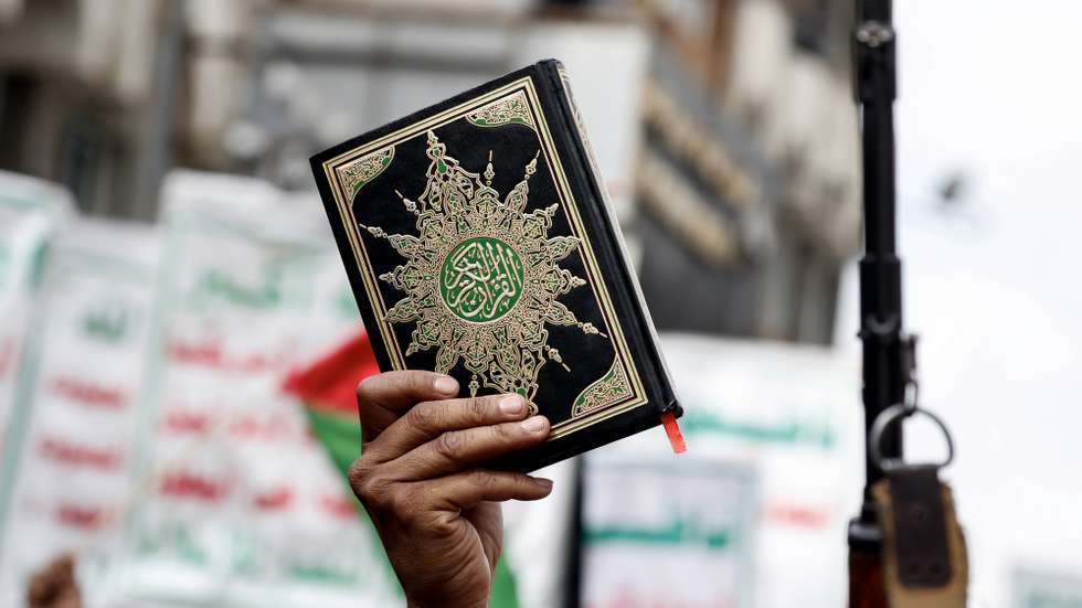 epa10726593 A Yemeni holds up a copy of the Koran during a protest against the burning of the Koran in Sweden, in Sana'a, Yemen, 04 July 2023. Yemenis staged a protest against Sweden for allowing an Iraqi man to burn a copy of the Koran outside of a mosque in Stockholm on 28 June.  EPA/YAHYA ARHAB