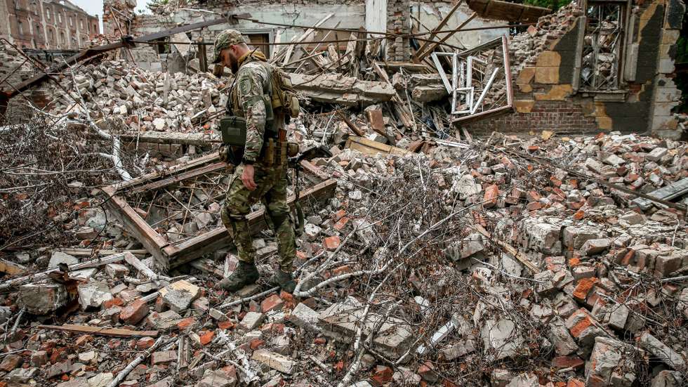 epa10758513 A Ukrainian serviceman of the 24 separate mechanized brigade named after King Danylo, walks amid the ruins of a building destroyed by Russian missile strikes in the Donetsk region, Ukraine, 20 July 2023. The war in Ukraine, which started when Russia entered the country in February 2022, marked in July its 500th day. According to the UN, since the conflict started, more than 9000 civilians have been killed and more than 6 million others are now refugees worldwide.  EPA/OLEG PETRASYUK