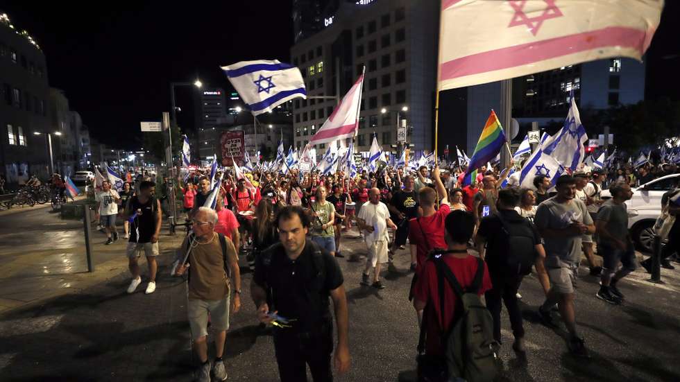 epa10772081 Anti-government demonstrators march during a protest against the Israeli judicial reform, in Tel Aviv, Israel, 27 July 2023. The Israeli parliament, or Knesset, passed a bill on 24 July that limits the Supreme Court's powers.  EPA/ATEF SAFADI
