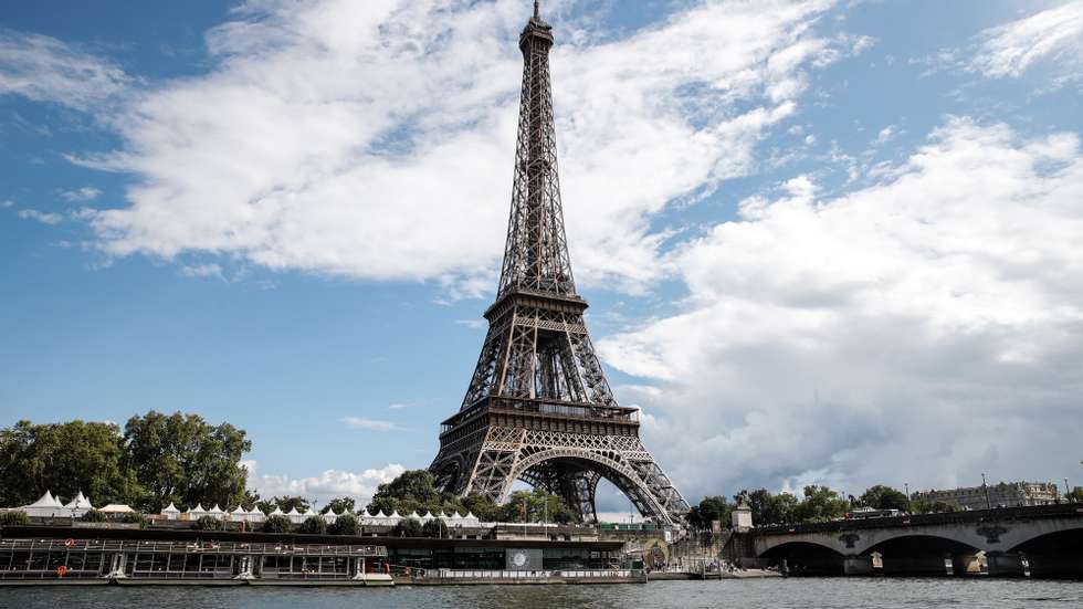 epa10784670 The Eiffel Tower next to the Seine River as it passes through Paris, France, 04 August 2023. A training session for athletes participating in the Open Water World Cup was canceled as the water quality dropped to levels below the standards following heavy rain, the international governing body of swimming announced.  EPA/TERESA SUAREZ