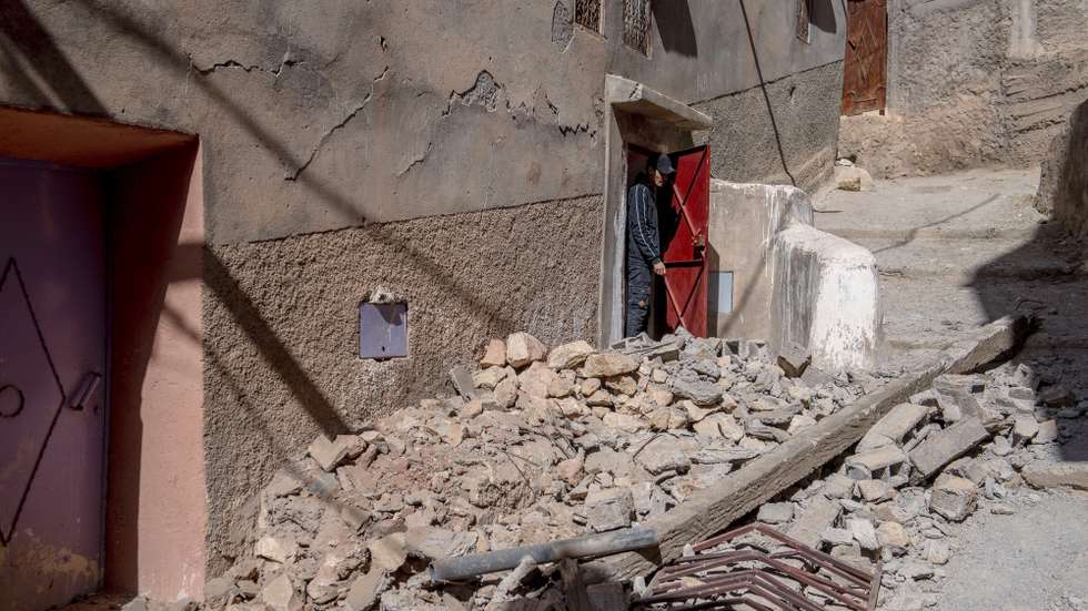 epa10850141 A person inspects the damage at the entrance to a building following an earthquake in Marrakesh, Morocco, 09 September 2023. A powerful earthquake that hit central Morocco late 08 September, killed at least 820 people and injured 672 others, according to a provisional report from the country's Interior Ministry. The earthquake, measuring magnitude 6.8 according to the USGS, damaged buildings from villages and towns in the Atlas Mountains to Marrakesh.  EPA/JALAL MORCHIDI