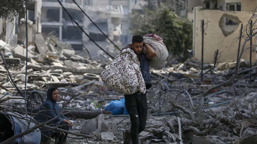 epa10911537 A Palestinian woman (L) sits among the rubble in the destroyed Al-Ramal neighborhood following an Israeli air strike in Gaza City, 10 October 2023. More than 700 people have been killed and around 4,000 have been injured according to the Palestinian Ministry of Health, after Israel started bombing the Palestinian enclave in response to an attack carried out by the Islamist movement Hamas on 07 October. More than 3,000 people, including 1,500 militants from Hamas, have been killed and thousands injured in Gaza and Israel since 07 October, according to Israeli military sources and Palestinian officials.  EPA/MOHAMMED SABER