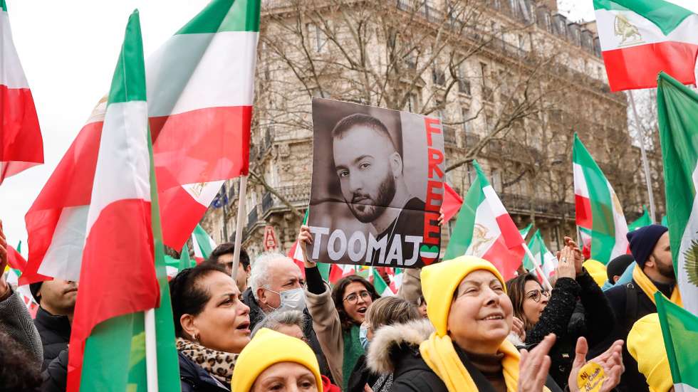 epa10463068 A woman holds a portrait of Iranian hip hop artist Toomaj Salehi, one of the main voices of the Iranian revolution, during a demonstration on the 44th anniversary of the Iranian revolution against Shahh Reza Pahlavi, in Paris, France, 12 February 2023. The protesters rejected the Shah's dictatorshipin the then Imperial State of Iran from 16 September 1941 until he was overthrown in the Iranian Revolution on 11 February 1979, and the following mullahs' theocracy and called for a democratic and secular government in Iran.  EPA/TERESA SUAREZ