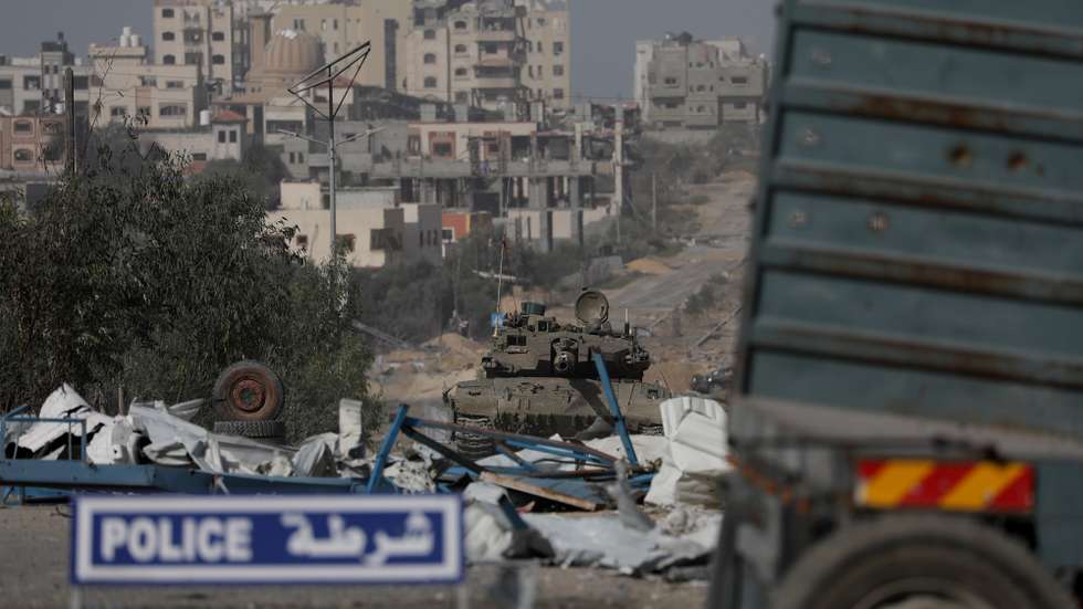 epa10996175 Israeli tanks move along Salah Al Din road in the central Gaza Strip, 26 November 2023. After Israel and Hamas agreed to a four-day ceasefire, mediated by Qatar, the US, and Egypt, that came into effect at 05:00 AM GMT on 24 November, some Palestinians who were still in central Gaza moved towards the south while others already displaced in the south went back to the northern part to check on relatives they had left behind and on their homes to collect salvageable belongings. As part of the ceasefire, the agreement included that 50 Israeli hostages, women and children, are to be released by Hamas. 150 Palestinian women and children that were detained in Israeli prisons are to be released in exchange.  EPA/MOHAMMED SABER