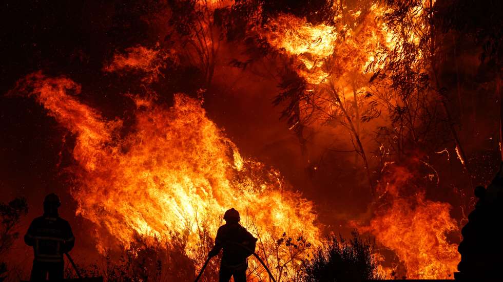 epa10998624 Firefighters work to put out the flames in the municipality of Odemira, 07 August 2023.  The fire, which broke out in the Baiona area, in the parish of Sao Teotonio, 05 August, has already forced the evacuation of four locations in the municipality of Odemira.  EPA/LUIS FORRA