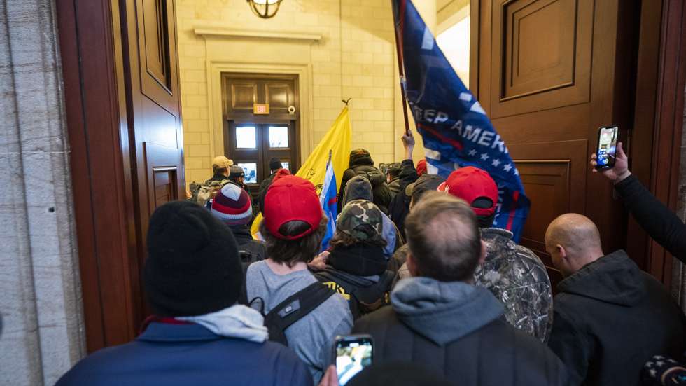 epa09664283 (12/24) (FILE) - Supporters of US President Trump stand by the door of the Eastern front after they breached the US Capitol security in Washington, DC, USA, 06 January 2021 (reissued 03 January 2021). Following the November 2020 US presidential election, a tone set by supporters of defeated US President Donald Trump escalated further. Trump, who was refusing to concede the victory of Joe Biden, claiming voter fraud and rigged elections, told supporters and white nationalist extreme-right group Proud Boys to respectively &#039;Stop the Steal&#039; and to &#039;stand back and stand by&#039;. His social media accounts were suspended and the alt-right platform Parler gained in user numbers. 
 
On 06 January 2021, incumbent US vice president Pence was due to certify the Electoral College votes before Congress, the last step in the process before President-elect Biden was to be sworn in. In the morning, pro-Trump protesters had gathered for the so-called Save America March. Soon after Trump finished his speech at the Ellipse, the crowd marched to the Capitol. The attack had begun. 
 
Rioters broke into the Capitol building where the joint Congress session was being held. Lawmakers barricaded themselves inside the chambers and donned tear gas masks while rioters vandalized the building, some even occupying offices such as House Speaker Pelosi&#039;s. Eventually in the evening the building was cleared from insurrectionists, and the Congress chambers reconvened their session, confirming Joe Biden as the winner of the 2020 US presidential election. 

In the aftermath, more than 600 people were charged with federal crimes in connection to the insurgency, and close Trump aides such as Steve Bannon, Mark Meadows and Roger Stone were subpoenaed by the House select committee investigating the attack. Trump himself was acquitted by the Senate in his second impeachment trial, this time for &quot;inciting an insurrection&quot;.  EPA/JIM LO SCALZO  ATTENTION: This Image is part of a PHOTO SET *** Local