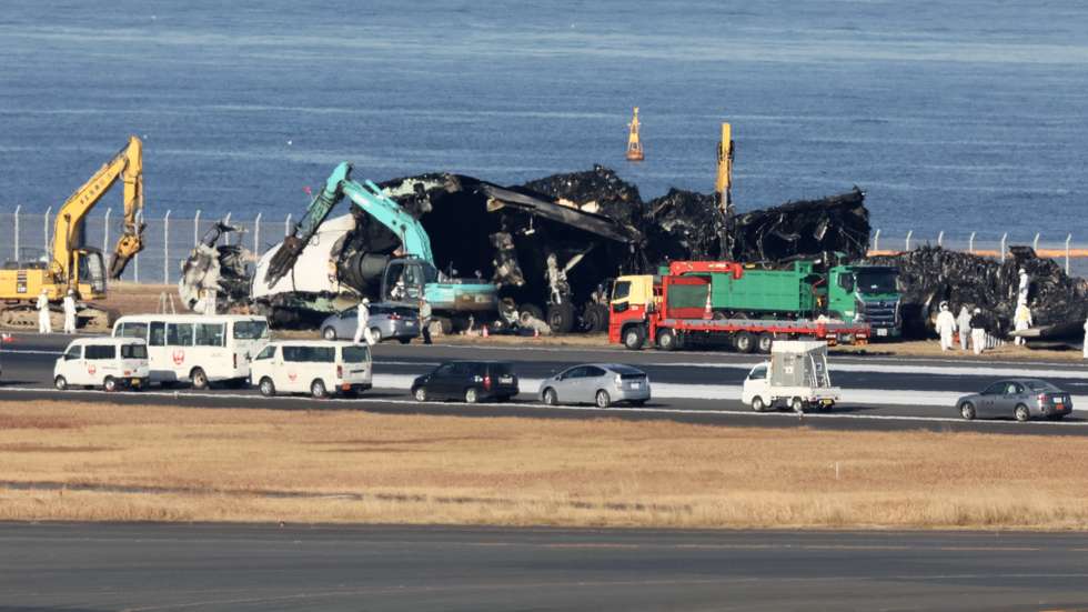 epa11058376 Workers start to remove wreckage following the crash of a Japan Airlines passenger plane with a Japan Coast Guard plane at Haneda Airport in Tokyo, Japan, 05 January 2024. The passenger plane carrying 367 passengers and 12 crew crashed with a Japan Coast Guard plane for transporting relief supplies for the earthquake hit areas. All passengers and crew on board the passenger plane evacuated safely. Tokyo Metropolitan Police confirmed five of six crew on board the Japan Coast Guard plane were dead. Japan Airlines announced on 03 January that the JAL aircraft recognized the controller's permission to land, read it back, and performed the landing operation. It appears that the Japan Coast Guard plane was already on the runway when it attempted to land, and the Japan Transport Safety Board and the Metropolitan Police Department are investigating the interaction between the controller and the two planes in detail to determine the cause of the accident.  EPA/JIJI PRESS JAPAN OUT EDITORIAL USE ONLY