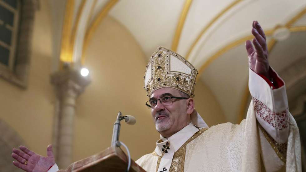 epa11043500 Latin Patriarch Pierbattista Pizzaballa, the top Catholic clergyman in the Holy Land, leads the Christmas midnight mass at the Church of the Nativity compound, in Bethlehem, the West Bank, 25 December 2023.  EPA/Nasser Nasser / POOL