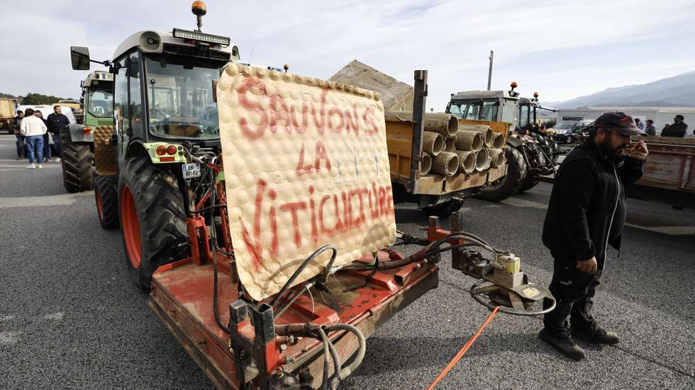 epa11118023 French farmers from the Occitanie region take part in a blockade of the A9 motorway at Le Boulou near the Spanish border, Southern France, 01 February 2024. French farmers continue their protests with road blockades and demonstrations in front of state buildings awaiting a response from the government to their request for 'immediate' aid of several hundred million euros. On 23 January, the EU Agriculture and Fisheries Council highlighted the importance of providing the conditions necessary to enable EU farmers to ensure food security sustainably and profitably, as well as ensuring a fair income for farmers. The banner reads 'Save the wineyard’.  EPA/GUILLAUME HORCAJUELO