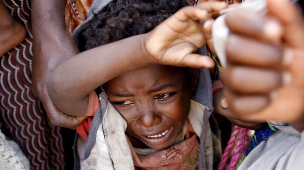 epa01507772 A young boy cries while waiting in line at an outreach clinic run by Medecins Sans Frontiers (MSF) (Doctors Without Borders) in the village of Faajjii Gollee, 250kms south of Addis Ababa, 01 October 2008. A lack of rain in the main February to April wet season has left at least 75,000 Ethiopian children under age five at risk from malnutrition, according to the UN's Office for the Coordination of Humanitarian Affairs (OCHA) who also asserts that some eight million people need urgent food relief and another 4.6 million need emergency assistance. 

Almost 40,000 people have received either therapeutic or enriched food through MSF nutrition activities in the South of Ethiopia over the last four months but according to staff crowds still throng at the entrance of the nutrition centres to try to get something to eat.  EPA/STEPHEN  MORRISON