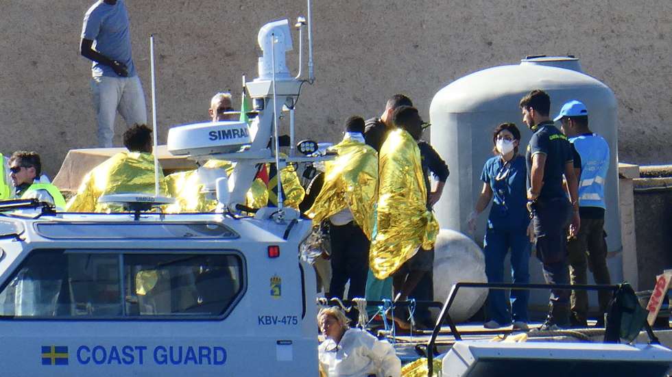 epa10970608 Migrants arrive aboard a Coast Guard patrol boat, after they were rescued in the waters off the island of Lampedusa, in Lampedusa, southern Italy, 11 November 2023. Thirty-nine Eritreans and Sudanese migrants, who had been traveling from Al Amra, Tunisia, on a boat which sank off Lampedusa island, were rescued by patrol boats of Italy's Guardia di Finanza (financial police) and Swedish Frontex unit, while a migrant's body was recovered.  EPA/ELIO DESIDERIO BEST QUALITY AVAILABLE