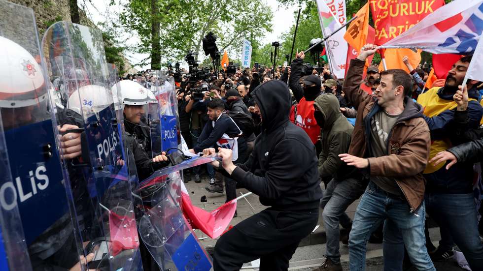 epa11312047 Protesters clash with riot police as they attempt to reach Taksim Square to celebrate the International Labor Day in Istanbul, Turkey, 01 May 2024. Thousands of protesters, including members of the main labor unions and leftist groups, gathered for a rally to reach Istanbul's Taksim Square as Turkish police sealed off the central square to prevent May Day demonstrations. The security measures came a day after Interior Minister Yerlikaya said authorities had designated 40 areas for May Day celebrations, excluding Taksim Square.  EPA/TOLGA BOZOGLU