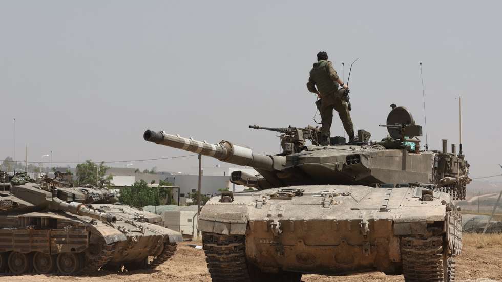 epa11357609 Israeli soldiers with their tanks gather at an undisclosed location near the border fence with the Gaza Strip, in southern Israel, 21 May 2024. The Israeli military stated on 21 May that they continued 'operational activities' throughout the Gaza Strip over the past day, where they dismantled some 70 targets. More than 35,000 Palestinians and over 1,400 Israelis have been killed, according to the Palestinian Health Ministry and the Israel Defense Forces (IDF), since Hamas militants launched an attack against Israel from the Gaza Strip on 07 October 2023, and the Israeli operations in Gaza and the West Bank which followed it.  EPA/ABIR SULTAN