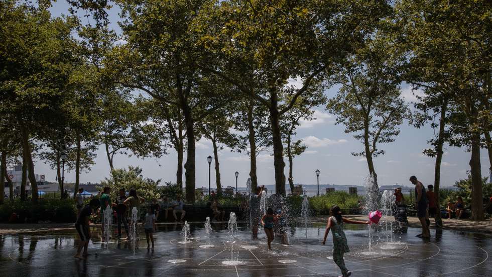 epa10774229 Children play in a water fountain during a heat wave at Battery Park in New York, New York USA, 28 July 2023. The East Coast is experiencing temperatures in the high 90's and a heat index of over 100 degrees Fahrenheit.  EPA/SARAH YENESEL 23441