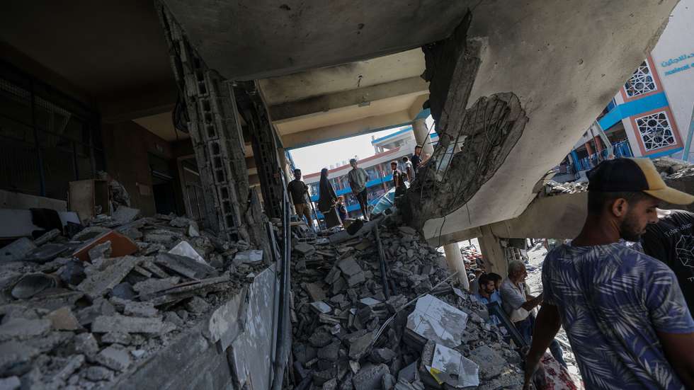epa11478181 Palestinians inspect a damaged UNRWA school following an Israeli air strike in Al Nuseirat refugee camp, central Gaza Strip, 14 July 2024. At least 12 people were killed following an Israeli air strike in the camp, according to the Palestinian Ministry of Health. The Israeli military stated on 14 July, that the Israeli Air Force (IAF) struck the area of UNRWA's Abu Oraiban School School building in Nuseirat, claiming that the location served as a 'hideout and operational infrastructure' to direct and carry attacks against Israeli troops operating in the Gaza Strip. More than 38,000 Palestinians and over 1,400 Israelis have been killed, according to the Palestinian Health Ministry and the Israel Defense Forces (IDF), since Hamas militants launched an attack against Israel from the Gaza Strip on 07 October 2023, and the Israeli operations in Gaza and the West Bank which followed it.  EPA/MOHAMMED SABER