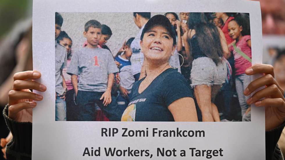 epa11256385 A protester holds up a placard of Australian aid worker Zomi Frankcom at a Pro-Palestine demonstration in Melbourne, Australia, 03 April 2024. Australian woman Zomi Frankcom is among a group of aid workers killed by an Israeli air strike while they were delivering food in Gaza.  EPA/JAMES ROSS AUSTRALIA AND NEW ZEALAND OUT