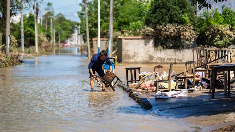 epaselect epa11513135 A villager cleans a chair at Huazhong Village of Hekou Town, Xiangtan County, central China's Hunan Province, July 31, 2024. Heavy rainfall has affected 1.15 million people in central China's Hunan Province since Friday, leading to direct economic losses of around 6.13 billion yuan (about 859.75 million U.S. dollars), local authorities said Wednesday. Heavy rainstorms from Typhoon Gaemi forced the evacuation of 95,000 people in the province, with 49,800 requiring emergency relief, according to preliminary statistics from the provincial flood control and drought relief headquarters.  EPA/XINHUA / Chen Sihan CHINA OUT / UK AND IRELAND OUT  /       MANDATORY CREDIT EDITORIAL USE ONLY