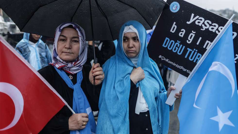 epa10893490 People hold banner and wave Turkish and East Turkestan flags as they protest against China's alleged human rights violations, near the Chinese Consulate in Istanbul, Turkey, 01 October 2023. The protest is held to call awareness for the situation of alleged human rights abuses committed against the Muslim Uyghur minority in China's Xinjiang (East Turkestan) area.  EPA/ERDEM SAHIN