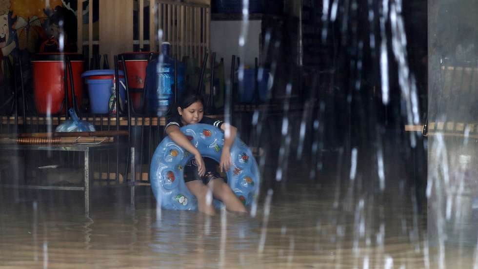 epa11597963 A girl sits inside her flooded home in Hanoi, Vietnam, 11 September 2024. Typhoon Yagi, which struck northern Vietnam over the weekend, triggered severe flooding in Hanoi. The Red River's rapid rise inundated communities along the riverbank, forcing residents to seek refuge in safer areas. As of 11 September, the Vietnam Disaster and Dyke Management Authority reported at least 152 fatalities and 140 missing persons due to the typhoon.  EPA/LUONG THAI LINH