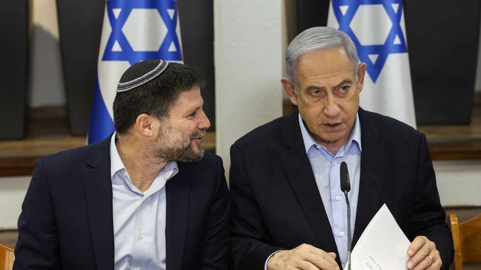 epa11062076 Israeli Prime Minister Benjamin Netanyahu (R) speaks with Minister of Finance Bezalel Smotrich during the weekly cabinet meeting at the Defence Ministry in Tel Aviv, Israel, 07 January 2024.  EPA/RONEN ZVULUN / POOL