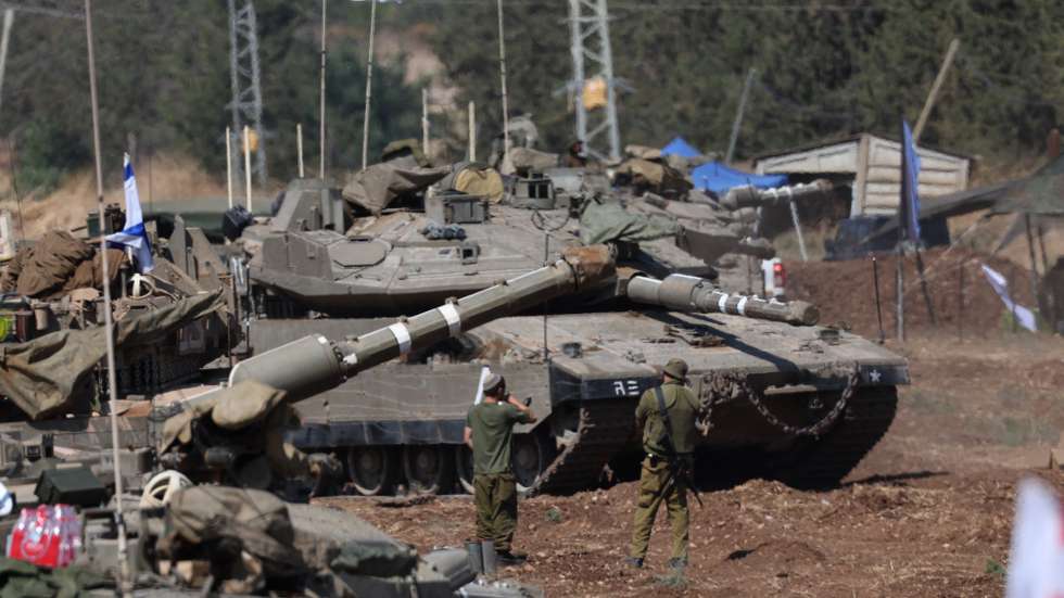 epa11633443 Israeli soldiers check military vehicles at a gathering site next to the border with Lebanon as seen from an undisclosed location in northern Israel, 30 September 2024. The Israeli military announced on 30 September that it had eliminated the head of the Lebanon Branch of Hamas during an ‘overnight joining IDF and ISA intelligence-based’ operation in Lebanon.