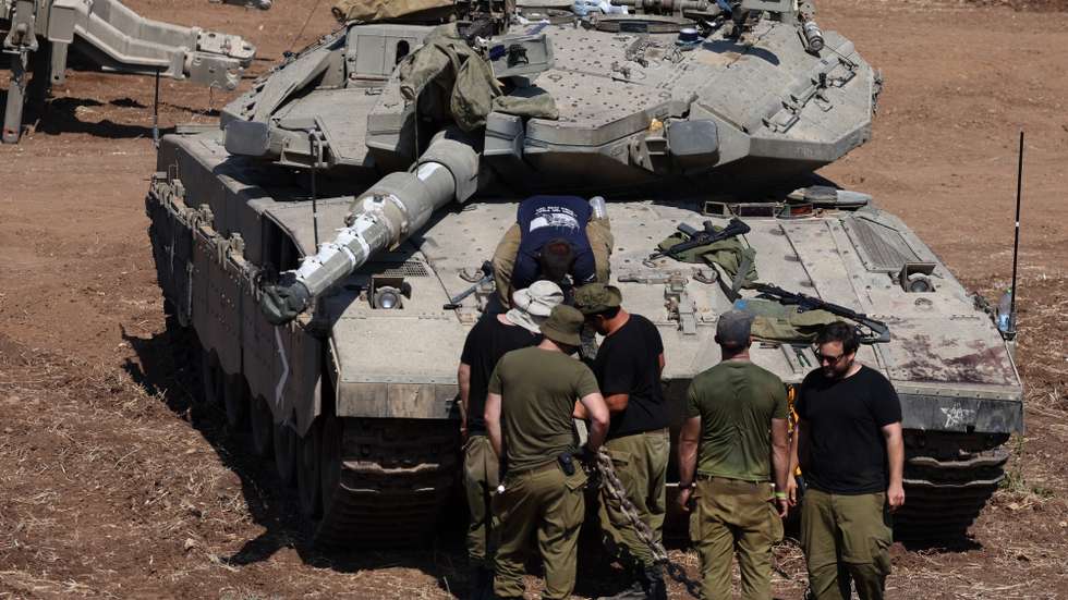 epa11633442 Israeli soldiers check military vehicles at a gathering site next to the border with Lebanon as seen from an undisclosed location in northern Israel, 30 September 2024. The Israeli military announced on 30 September that it had eliminated the head of the Lebanon Branch of Hamas during an ‘overnight joining IDF and ISA intelligence-based’ operation in Lebanon.