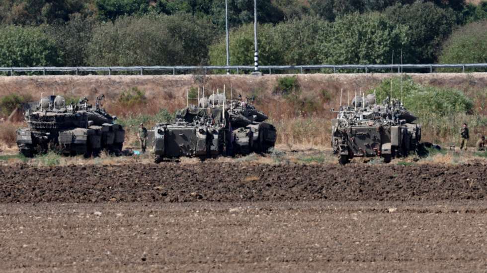 epa11639325 Israeli soldiers and military vehicles gather next to the border with Lebanon, at an undisclosed location along the Israeli side of the border, northern Israel, 03 October 2024. The Israeli army reported on 03 October that overnight the IAF had struck the Bint Jbeil municipality building &#039;in which Hezbollah were operating, alongside large quantities of Hezbollah weapons stored in the building&#039;.  EPA/ATEF SAFADI