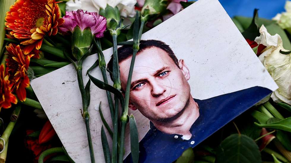 epaselect epa11191168 A portrait of late Russian opposition leader Alexei Navalny sits among floral tributes and a candle outside the Russian embassy in Berlin, Germany 01 March 2024. Outspoken Kremlin critic Navalny died aged 47 in an arctic penal colony on 16 February 2024 after being transferred there in 2023. The colony is considered to be one of the world’s harshest prisons.  EPA/FILIP SINGER