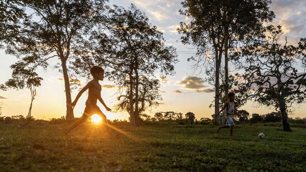 epa11423301 Children play soccer in an indigenous village in the Amazon rainforest, Brazil, 14 June 2024 (issued 19 June 2024). The extraction of natural gas in the middle of the Brazilian Amazon has put the Mura people on the warpath. While the authorities speak of development for the region, this ethnic group fears for the rivers and forests on which it lives and has initiated a legal struggle to stop the project.  EPA/Antonio Lacerda