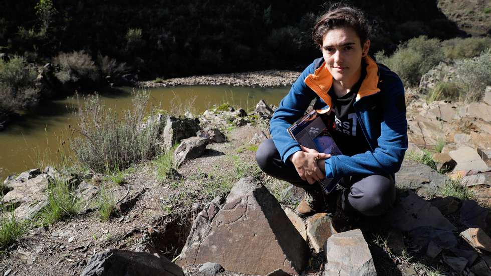 Sara Garcês, investigadora e arqueóloga do Instituto Politécnico de Tomar e Instituto Terra e Memória em Mação, posa para a fotografia junto à gravura rupestre com mais de 20 mil anos, que representa a figura de um cavalo, e que foi descoberta no vale do Ocreza, Mação, 11 de outubro de 2024. Esta descoberta de arte paleolítica gravada na rocha é representativa de um cavalo sem cabeça, a exemplo da primeira gravura encontrada naquele vale, no ano 2000, o ‘Cavalo do Ocreza’ e que, apesar de ser mais pequena em dimensão, pode indiciar “um padrão” de estilo rupestre. (ACOMPANHA TEXTO DE 19-10-2024) PAULO CUNHA/LUSA