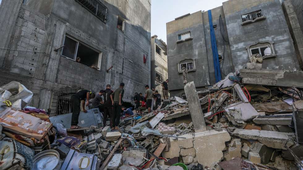 epa11668052 Palestinians search for bodies and survivors among the rubble of the destroyed house of the Al-Tilbany family following an Israeli air strike in Al-Maghazi refugee camp in the Gaza Strip, 19 October 2024. According to a report from the Ministry of Health in Gaza, at least eight members of the Shnaa family were killed following an Israeli air strike in the camp. More than 42,500 Palestinians and over 1,400 Israelis have been killed, according to the Palestinian Health Ministry and the Israel Defense Forces (IDF), since Hamas militants launched an attack against Israel from the Gaza Strip on 07 October 2023, and the Israeli operations in Gaza and the West Bank which followed it.  EPA/MOHAMMED SABER