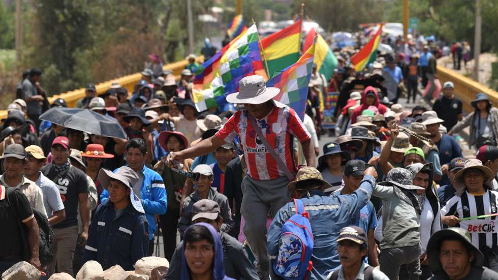 epa11691078 Supporters of former Bolivian president Evo Morales march on a blocked road in Parotani, Bolivia, 29 October 2024. For 16 days, Morales' supporters have been blocking roads to demand the withdrawal of legal proceedings for rape and human trafficking against the former president, along with demands for a solution to the economic situation and the defense of the official leader's presidential candidacy for 2025.  EPA/LUIS GANDARILLAS
