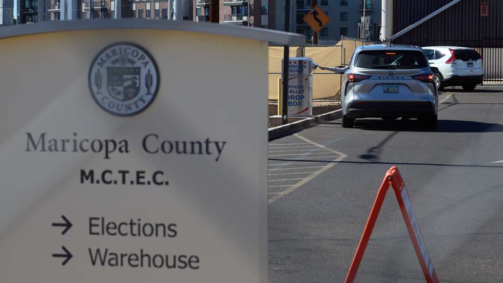 epa11701532 A voter drops off an election ballot at a drive thru drop box at the Maricopa County Tabulation and Election Center in Phoenix, Arizona, USA, 04 November 2024. Maricopa County Elections, serving more than 2.4 million registered voters, is responsible for candidate filings, in-person voting and vote centers, hiring thousands of elections workers for each election, as well as the tabulation of ballots. The US general election takes place on 05 November 2024.  EPA/ALLISON DINNER