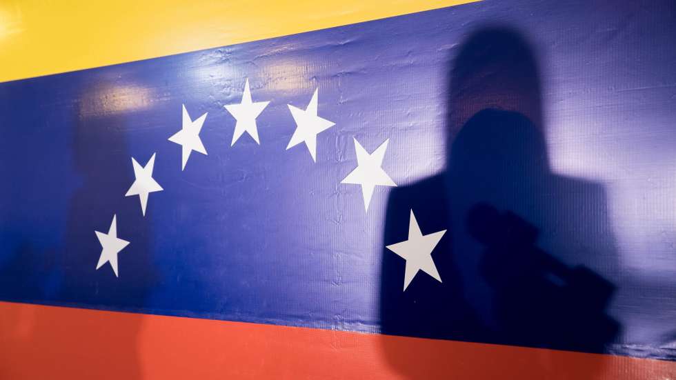 epa10937196 The shadow of former deputy Maria Corina Machado is cast on the Venezuelan flag while she offers statements to journalists in Caracas, Venezuela 24 October 2023. Former deputy Maria Corina Machado, winner of Sunday's opposition primaries in Venezuela, called this 24 October on 'all' sectors and actors in the country to work on the 'construction' of the presidential route for 2024, when she hopes to participate in the elections for defeat Chavismo.  EPA/MIGUEL GUTIERREZ