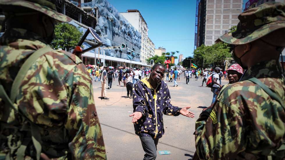 Um manifestante conversa com militares durante uma marcha de contestação das eleições de 09 de outubro em Maputo, Moçambique, 29 de novembro de 2024. LUÍSA NHANTUMBO/LUSA