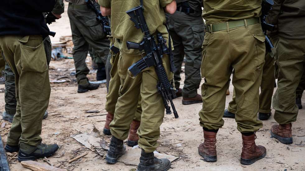 epa10989464 Israeli soldiers stand guard near the security fence along the border with the Gaza Strip during a press visit at Kfar Aza Kibbutz, southern Israel, 22 November 2023. The kibbutz, located near the Gaza border, was the scene of an Hamas attack on 07 October which resulted in the deaths of dozens of Israelis. More than 12,700 Palestinians and at least 1,200 Israelis have been killed, according to the Israel Defense Forces (IDF) and the Palestinian health authority, since Hamas militants launched an attack against Israel from the Gaza Strip on 07 October, and the Israeli operations in Gaza and the West Bank which followed it.  EPA/CHRISTOPHE PETIT TESSON