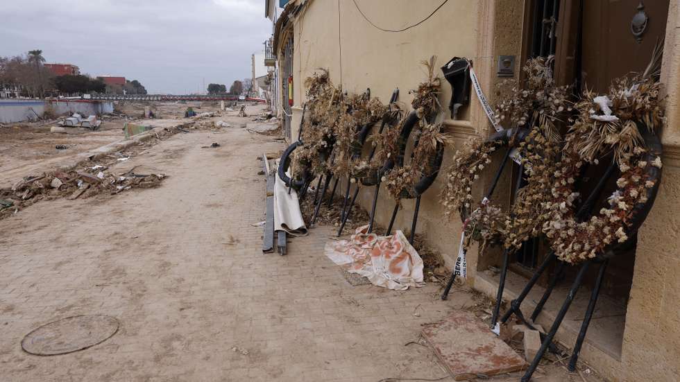 epa11793752 Dried flower wreaths lean on a wall at the Poyo ravine in the flood-hit town of Picanya, Valencia, eastern Spain, 26 December 2024. Floods triggered by the DANA (high-altitude isolated depression) weather phenomenon hit the east of Spain on 29 October 2024, devastating Valencia and neighboring provinces and leaving at least 229 people dead.Â   EPA/Kai Foersterling