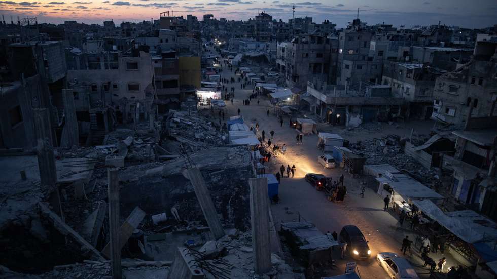 epaselect epa11834340 Palestinians walk through a market in Khan Younis, southern Gaza Strip, 18 January 2025. A ceasefire between Israel and Hamas will take effect on 19 January 2025. More than 46.000 people have been killed in Gaza since October 2023, when Israel launched a military campaign in response to a cross-border attack by Hamas, in which about 1,200 people were killed and over 200 taken hostage.  EPA/HAITHAM IMAD