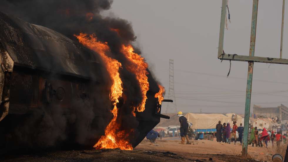 epa11834749 The wreckage of a fuel tanker burns at the Dikko junction, a road linking Abuja to Kaduna, Nigeria, 18 January 2025. According to the National Emergency Agency, over 78 burned bodies were recovered at the scene after the fuel tanker overturned and spilled the cargo, killing people who had gathered to take the spilled fuel.  EPA/AFOLABI SOTUNDE