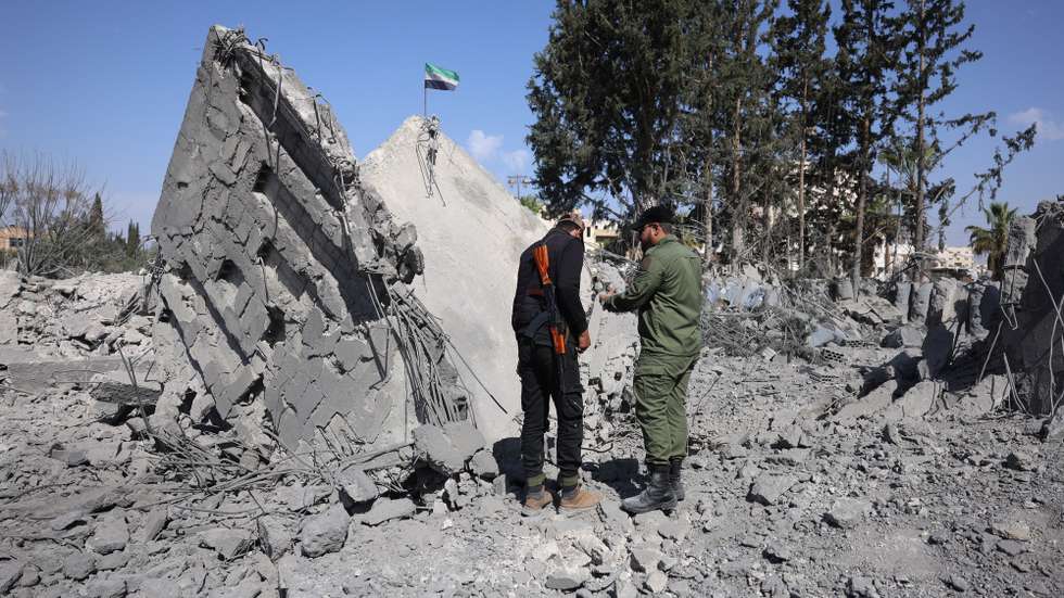 epa11971287 Syrian security forces inspect a destroyed building a day after an Israeli airstrike struck the city of Daraa in southern Syria, 18 March 2025. At least three people were killed and dozens were wounded in the airstrike late 17 March, Syrian state news agency SANA reported.  EPA/MOHAMMED AL RIFAI