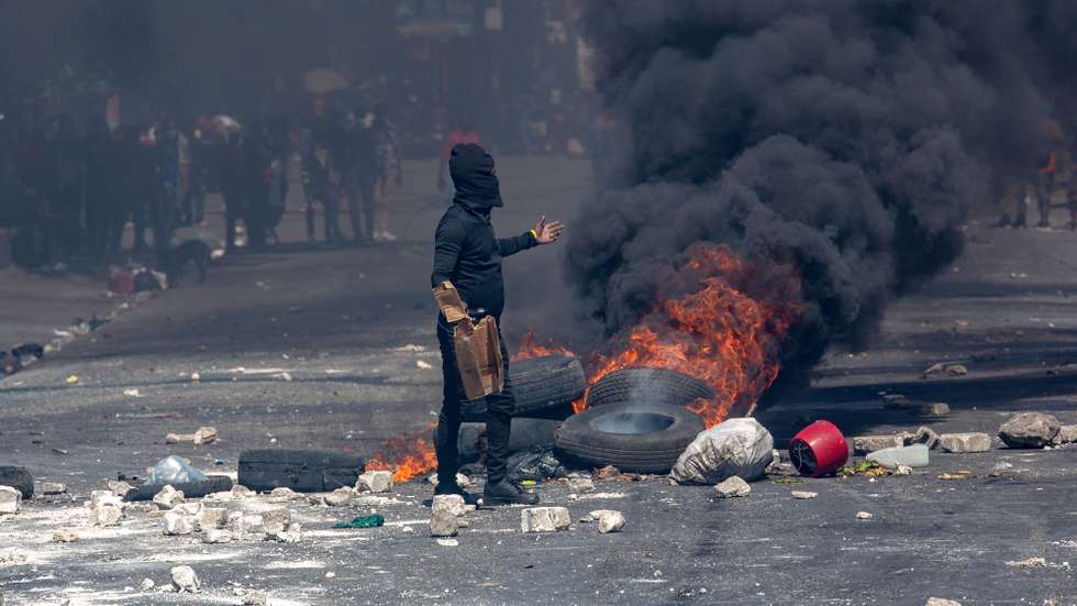 epa12006408 A protester takes part in a demonstration demanding authorities take action to address the growing wave of violence in Port-au-Prince, Haiti, 02 April 2025.  EPA/MENTOR DAVID LORENS