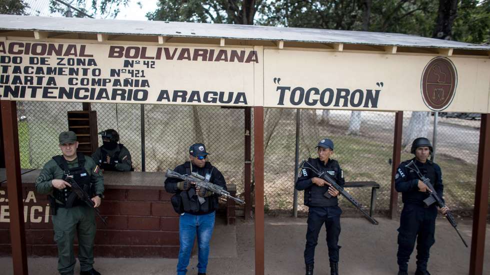 epa10879666 Soldiers stand at the entrance to the Tocoron penitentiary center during an operation in Tocoron, Venezuela, 23 September 2023. Remigio Ceballos, Minister of the Interior and Justice of Venezuela, denied that there had been "any negotiation" with criminal gangs, including the transnational "Tren de Aragua", during the police and military intervention at Tocoron prison, in the north of the country, carried out on 20 September with the deployment of more than 11,000 officials.  EPA/MIGUEL GUTIERREZ
