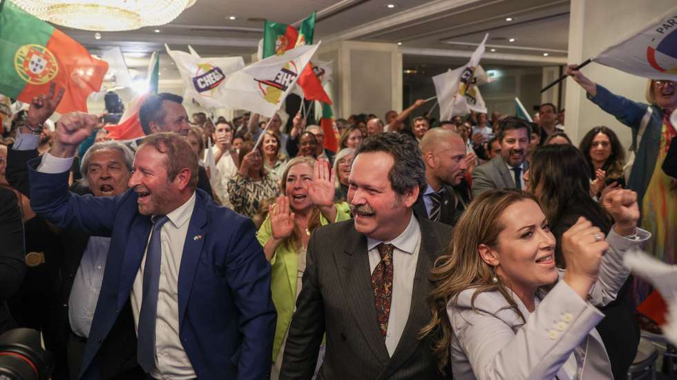 epa12115423 Supporters of the right party Chega (Enough) cheer to the projected results on the evening of legislative elections 2025 at Party's campaign headquarters in Lisbon, Portugal, 18 May 2025. More than 10.8 million voters living in Portugal and abroad will be asked to vote in these early parliamentary elections and choose from among the 21 competing political forces the party they believe should form the next government and elect the 230 seats of the Assembly of the Republic for the next legislature.  EPA/TIAGO PETINGA